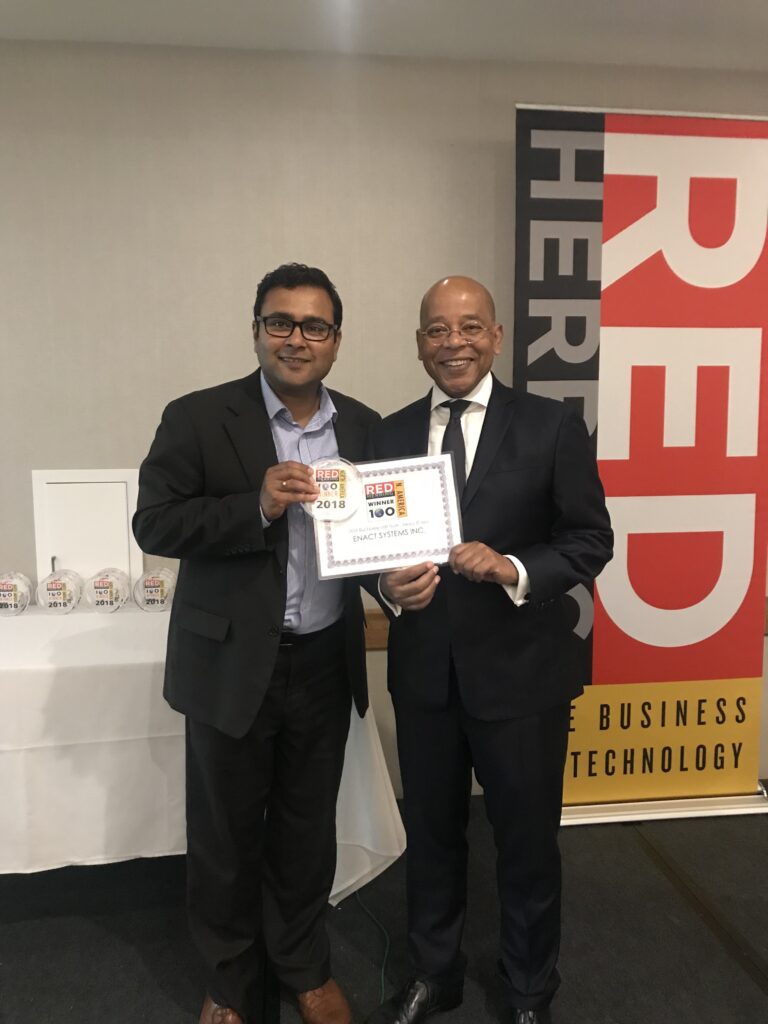 Image of Deep Chakraborty, CEO of Enact accepting the Red Herring Award in 2023