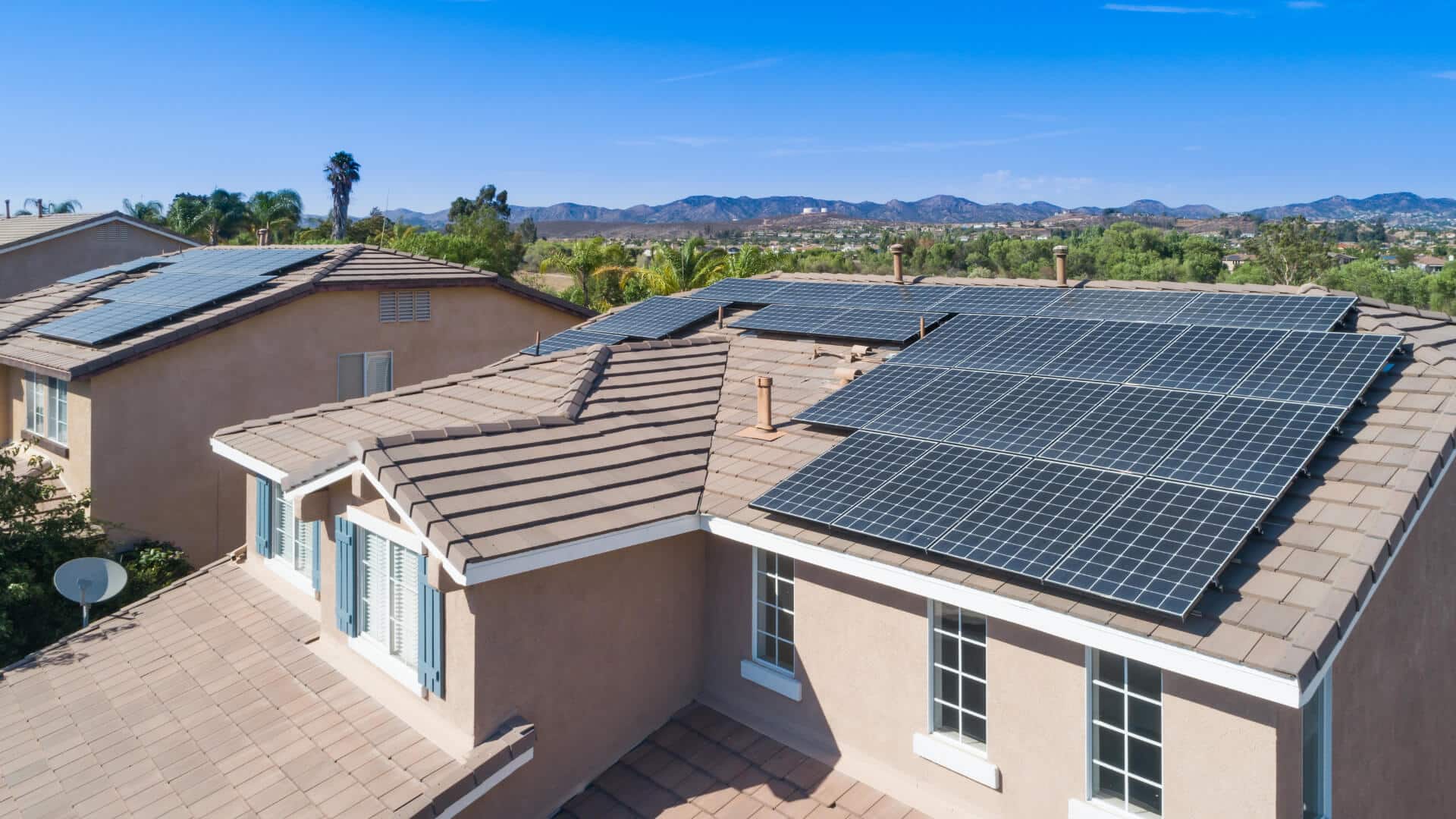 A residential home in a Sun Belt state, such as California, with a rooftop solar panel system. California leads the nation in the most cumulative home solar installations.