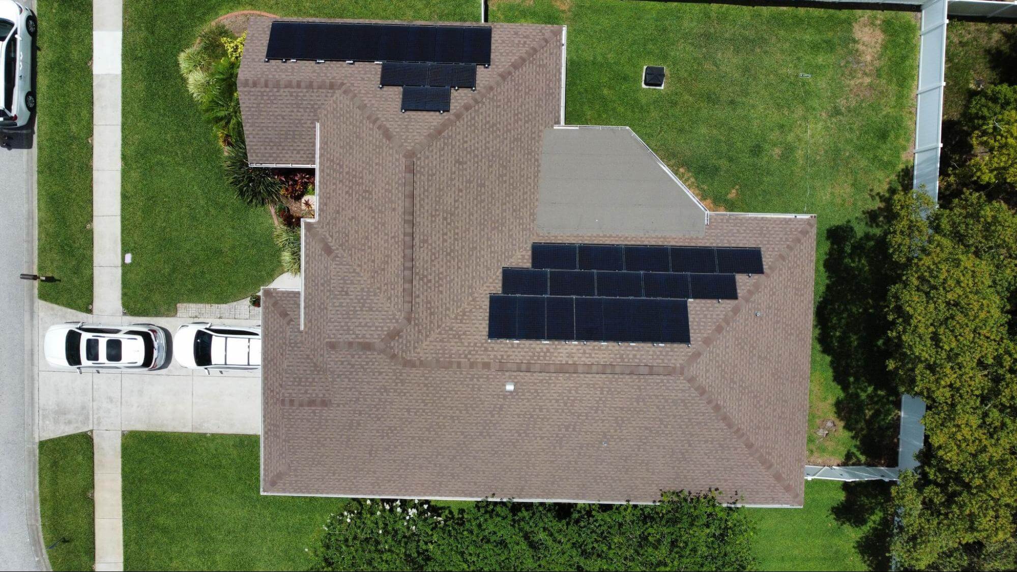 An aerial view of a home with a rooftop solar panel system. Homeowners do not need to live in a top five state for solar to receive the benefits of solar. Solar can help cut electrical bills and generate clean energy.