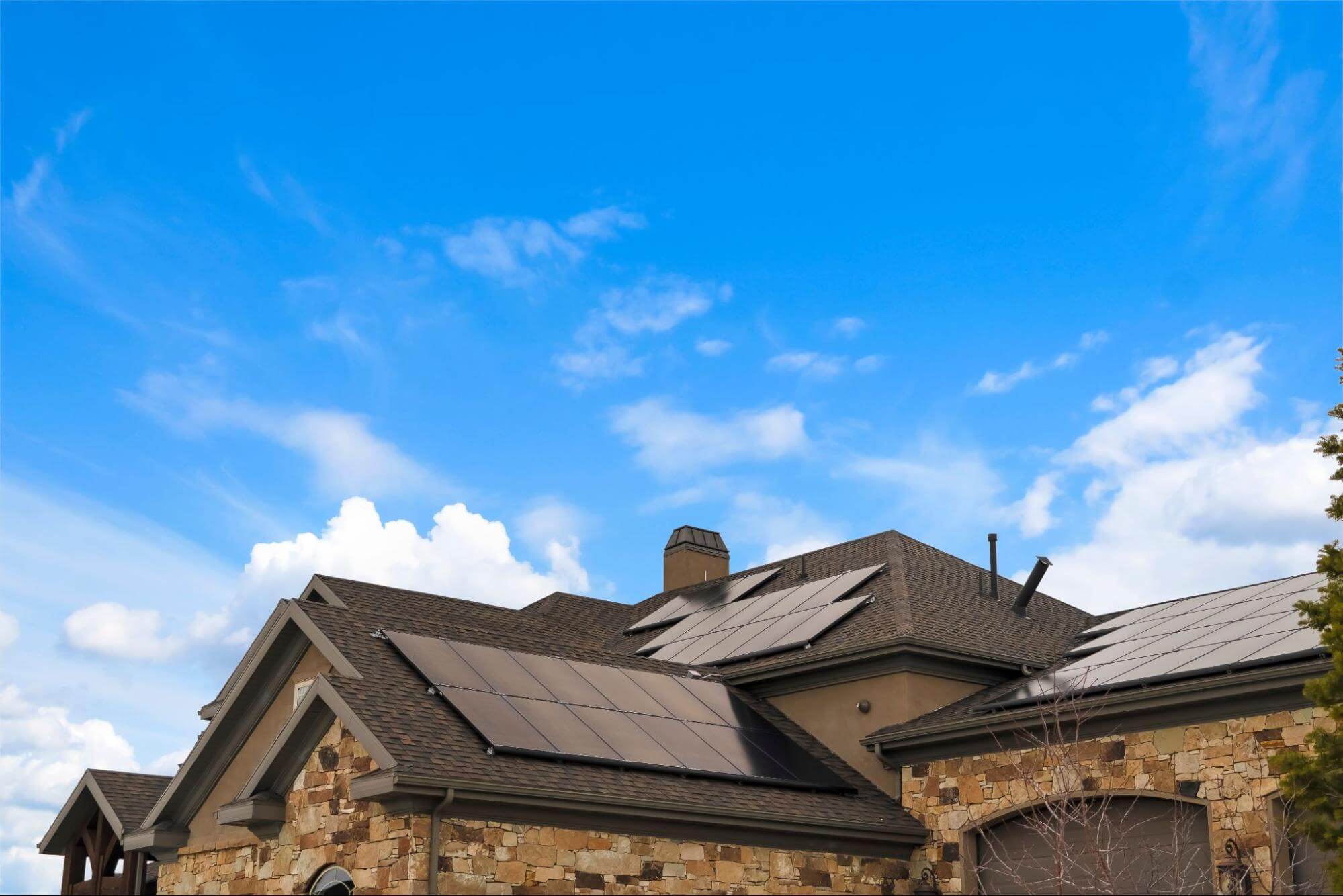 A modern house with a sleek rooftop solar panel system. Home solar is becoming more popular across the U.S. thanks to federal and state level incentives.